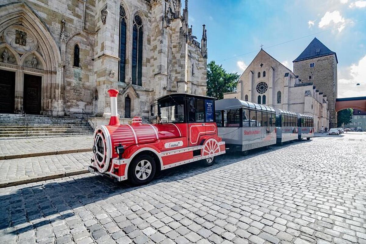 a red train parked in front of a church