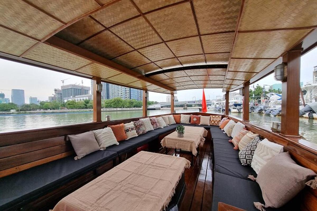 a boat with couches and tables on the water