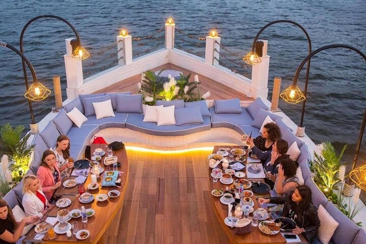 a group of people sitting around a table on a boat