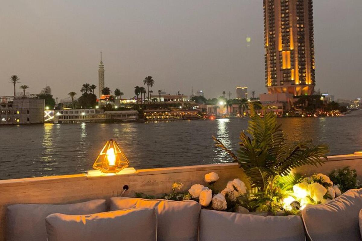 a view of a river with couches and a building