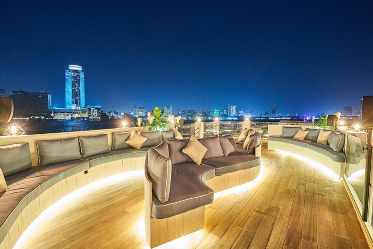 a rooftop deck with couches and a view of the city