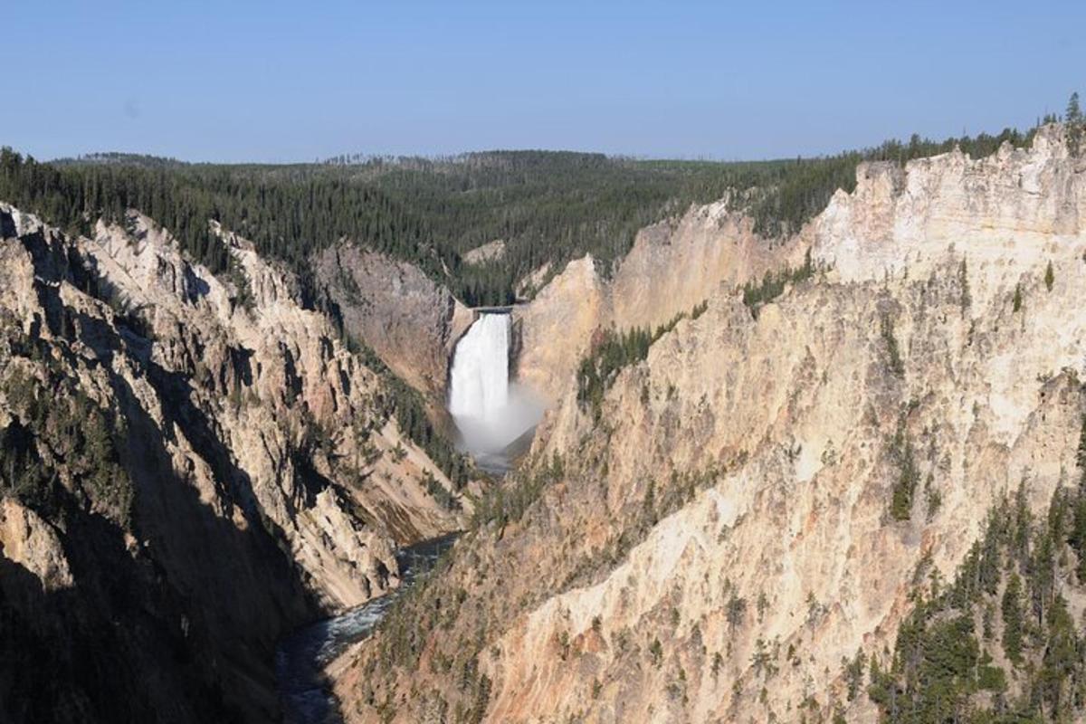 an aerial view of a waterfall in a canyon