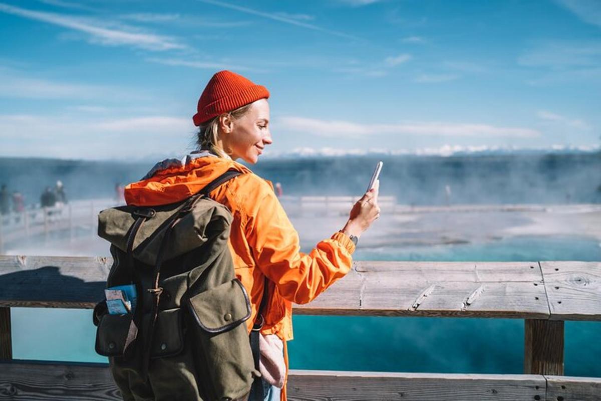 a woman with a backpack looking at a cell phone
