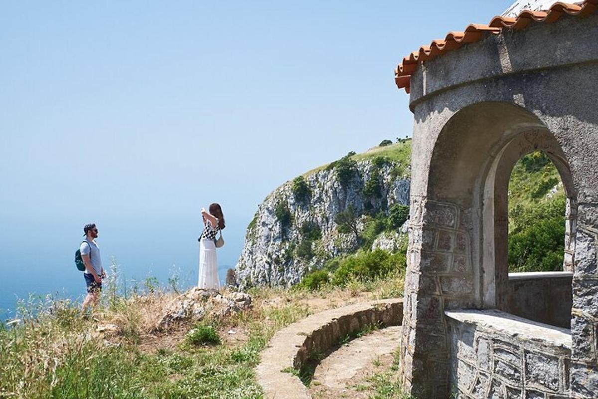 a man and a woman taking a picture on a hill