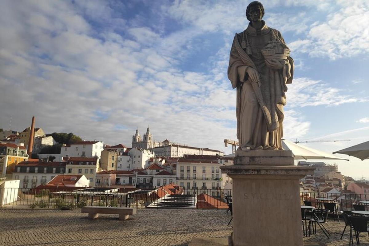 a statue of a man on a pedestal in front of a city