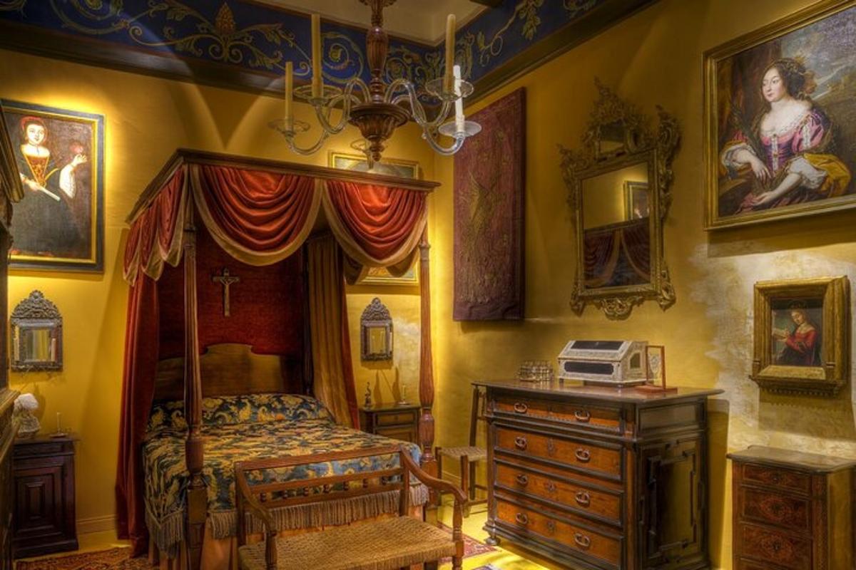 a bedroom with a canopy bed and a dresser in it