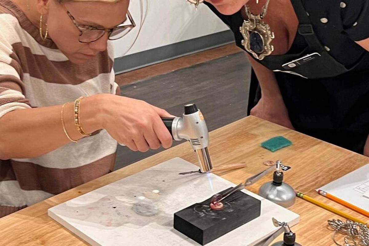 a woman using a sewing machine on a table