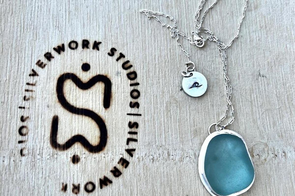 a necklace with a blue stone on a silver chain