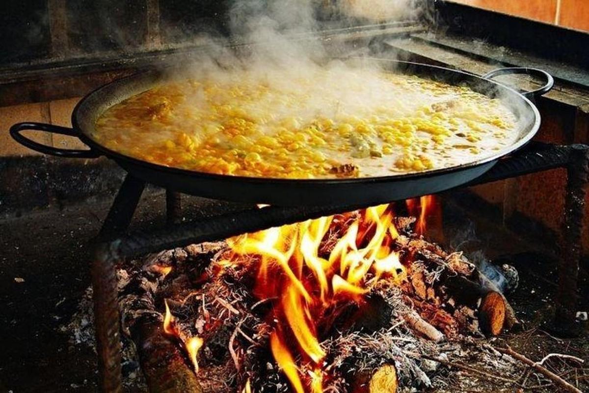 a pan of food cooking on top of a fire