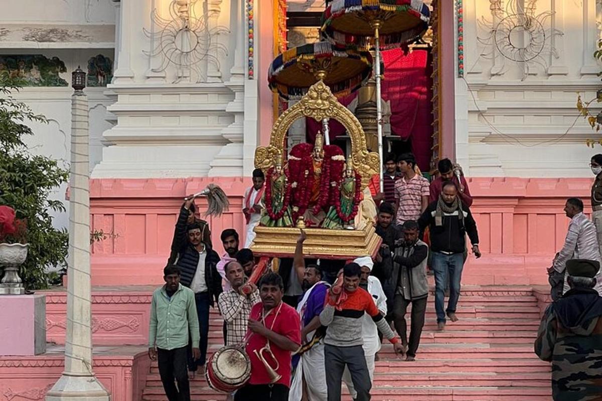 a group of people walking up the steps of a temple