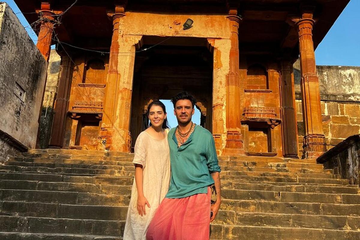 a man and a woman standing in front of a building