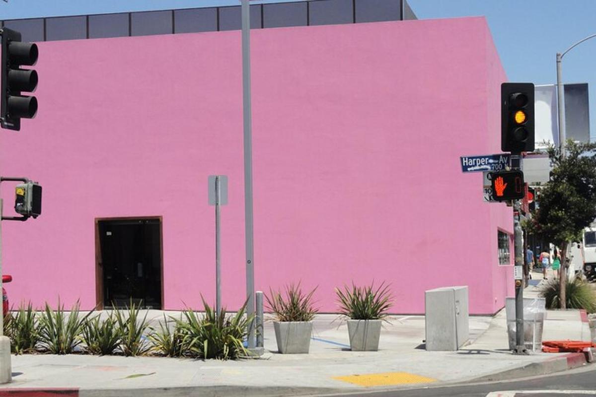 a pink wall on the side of a building