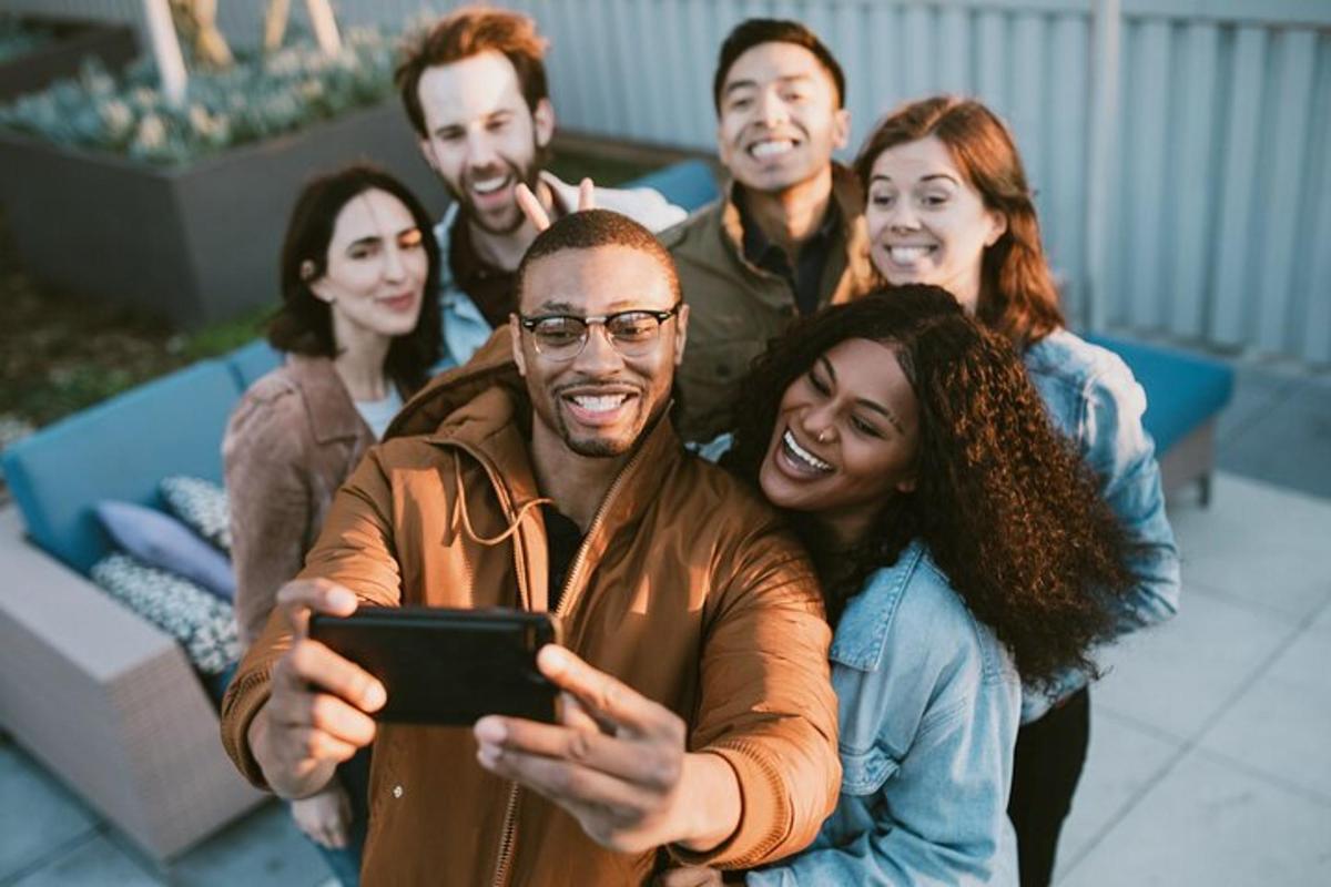 a group of people looking at a cell phone