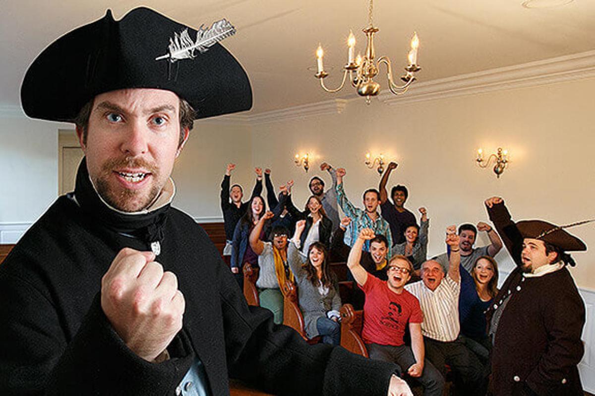 a man wearing a pirate hat in front of a group of people