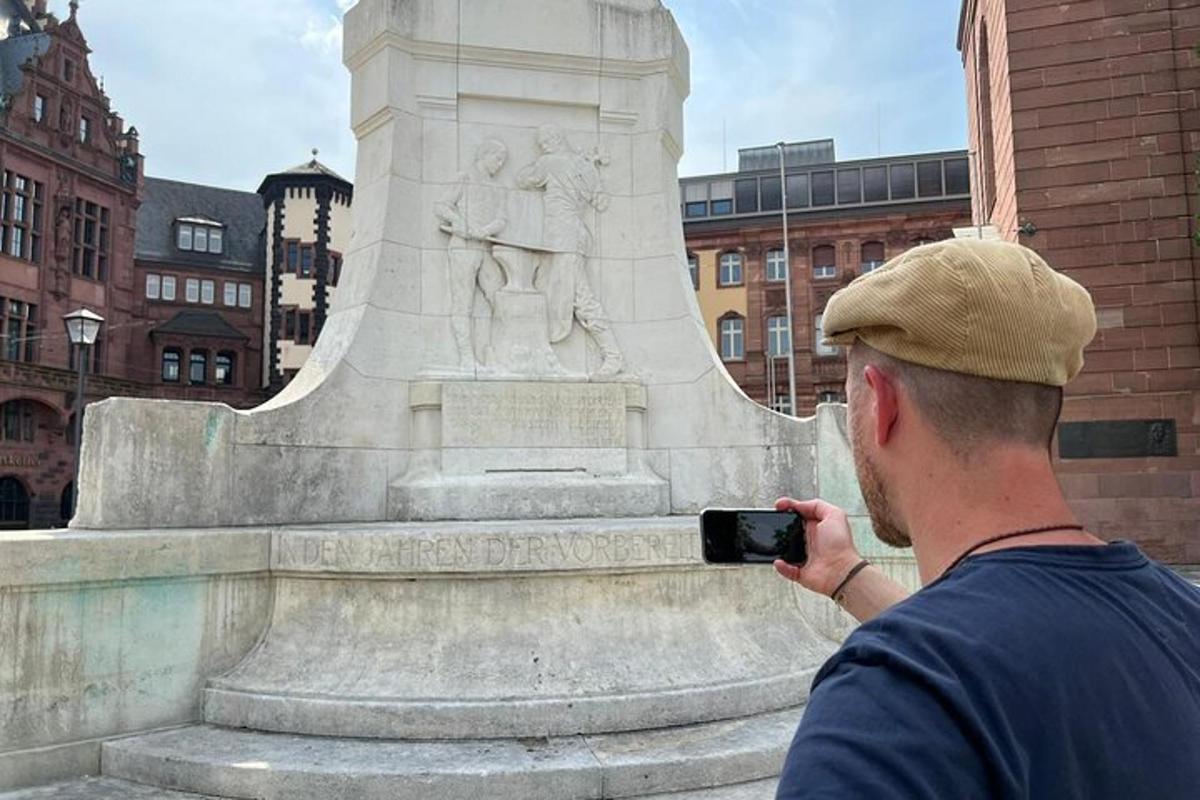 ein Mann, der ein Foto von einer Statue macht