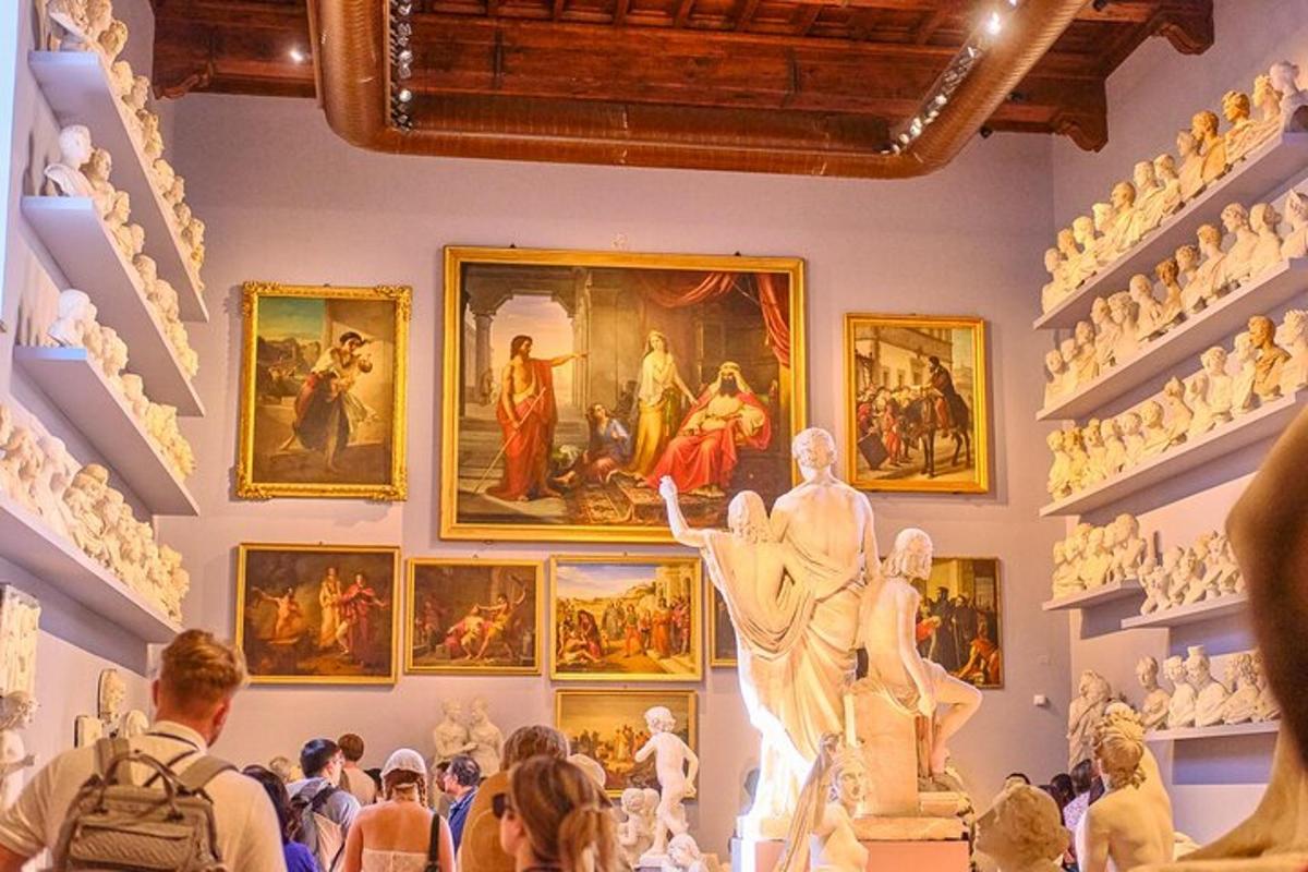 a crowd of people looking at paintings in a museum