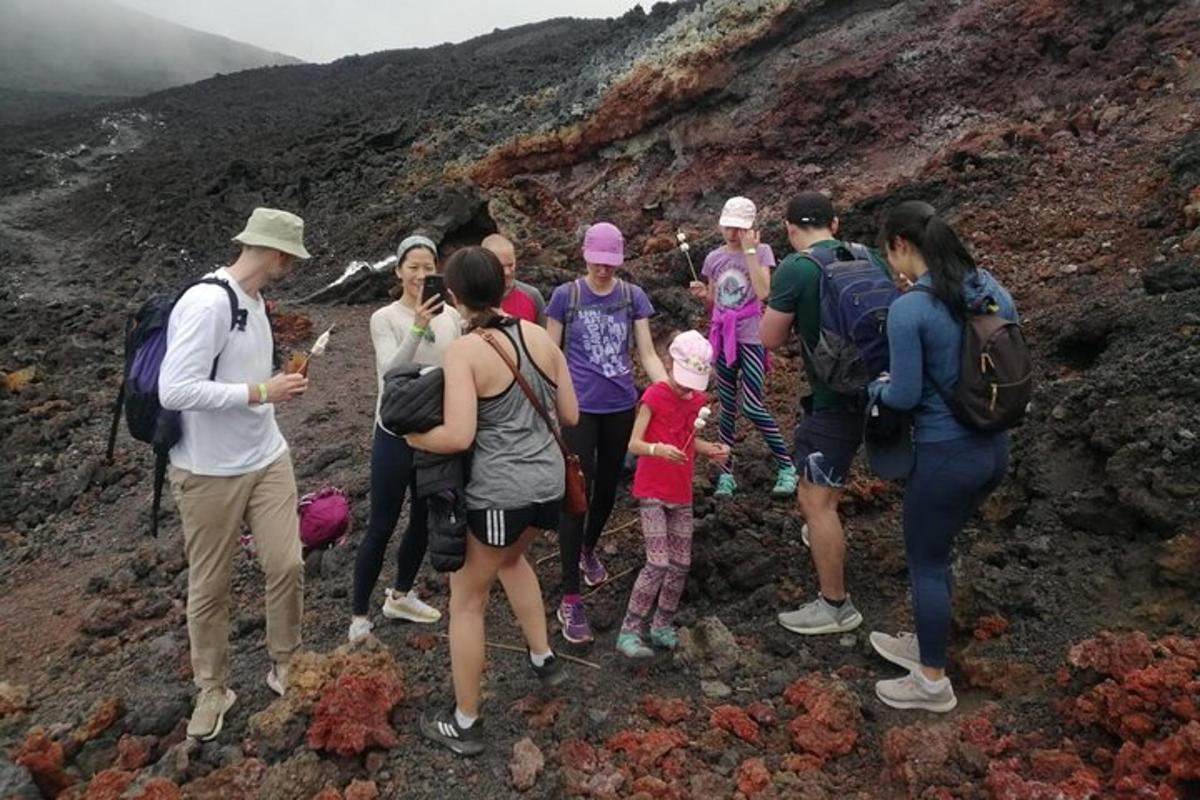 a group of people standing on the side of a mountain
