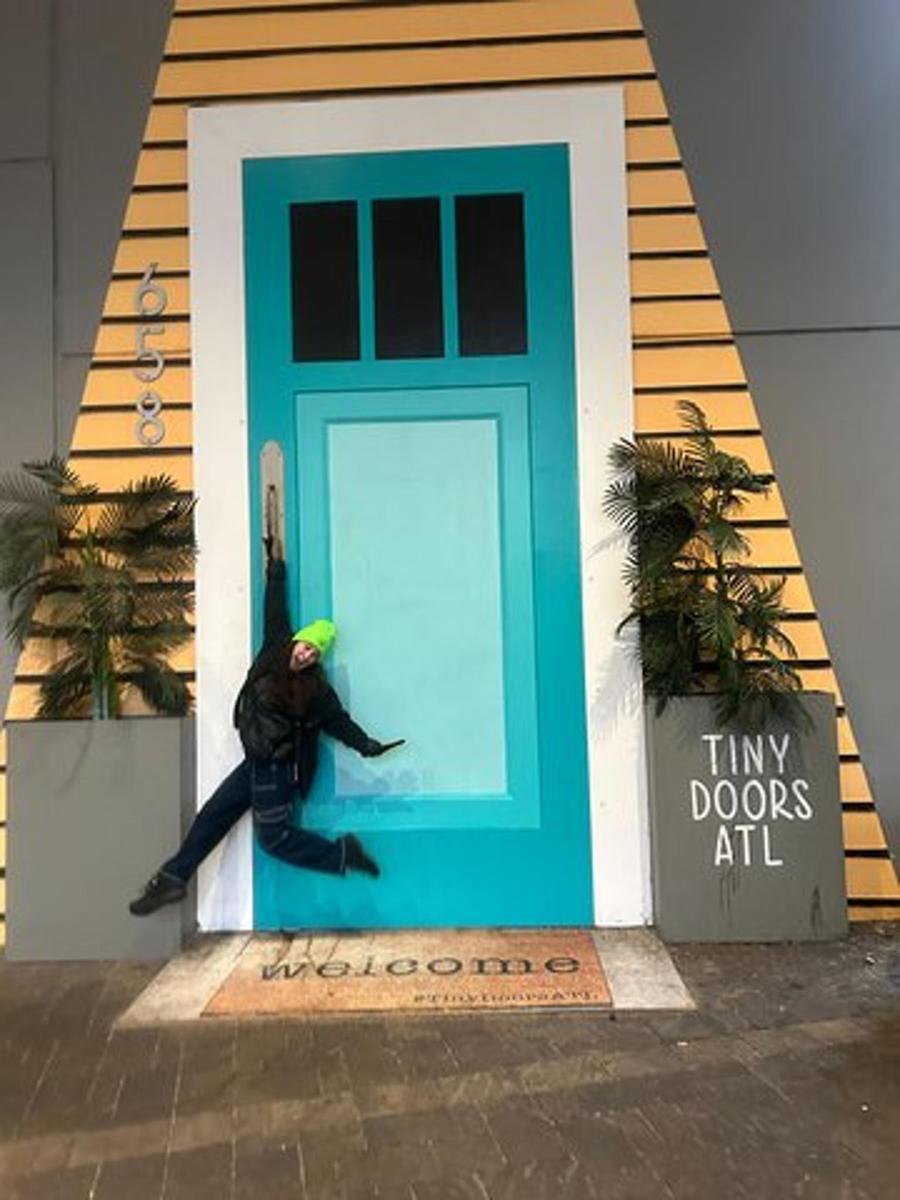 a person jumping in front of a blue door