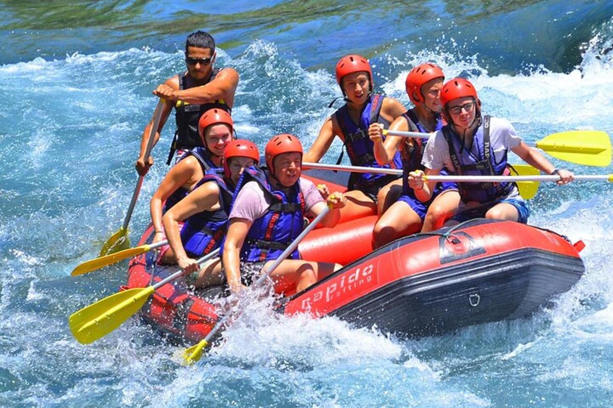 a group of people in a raft in the water