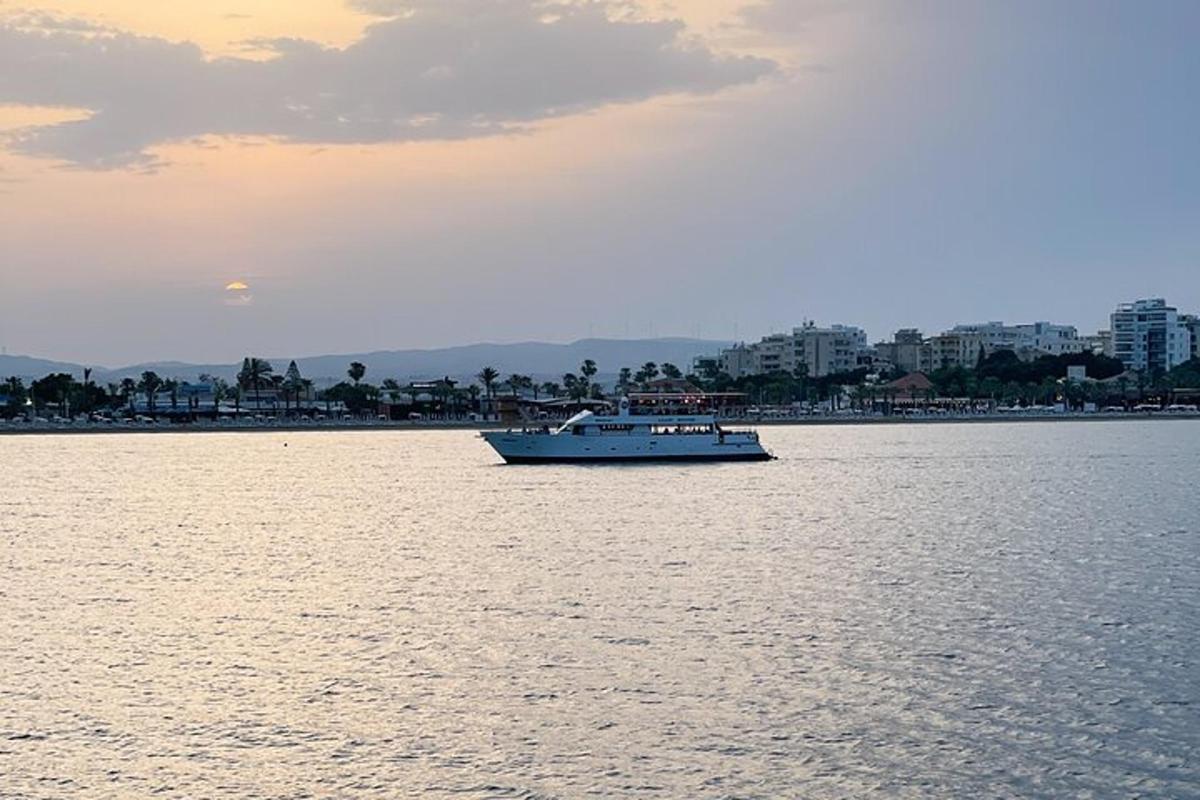 a boat in the water with a city in the background
