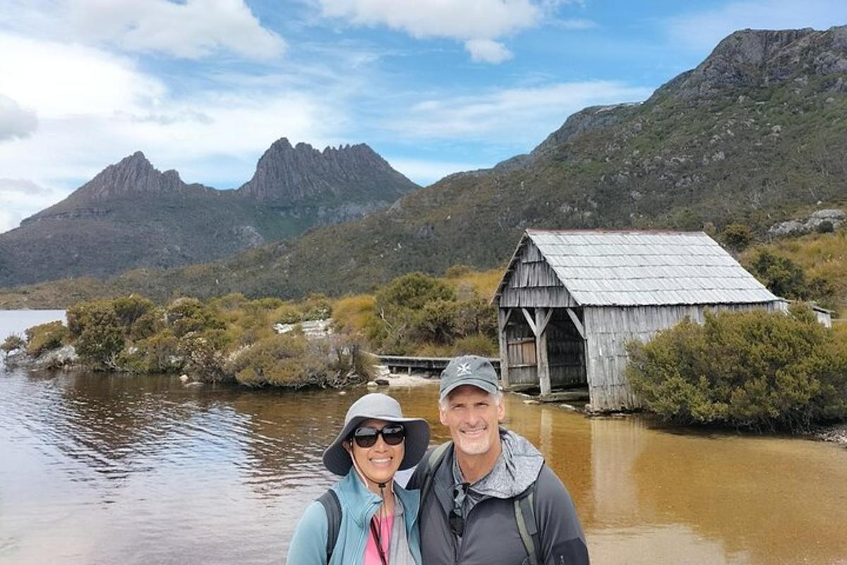 a man and woman standing in front of a body of water