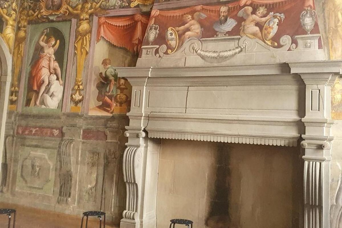 a room with a fireplace with paintings on the wall