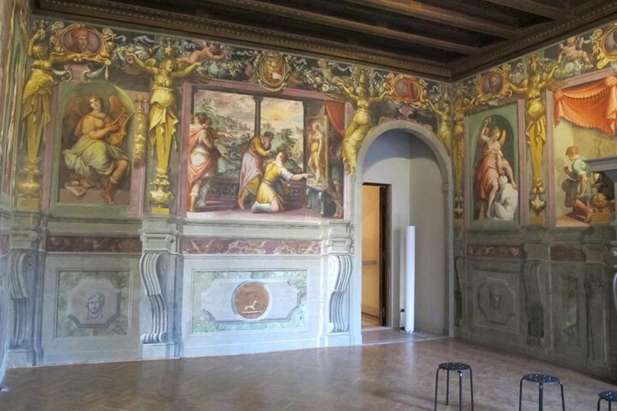 a room with a wall with paintings on the walls