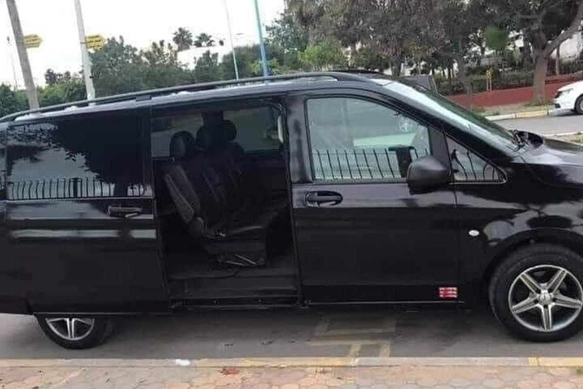 a black van parked in a parking lot with its door open