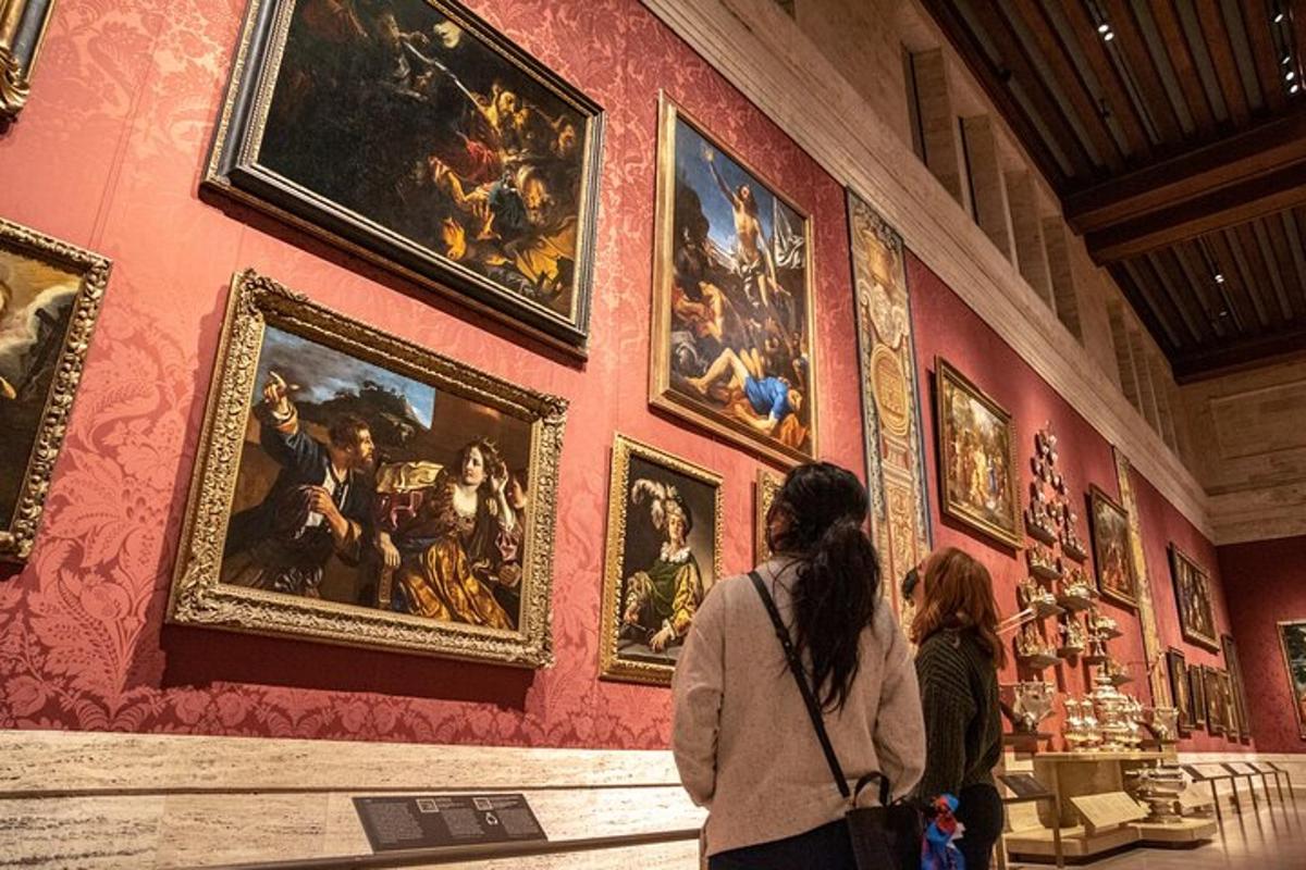 a group of people looking at a wall with paintings