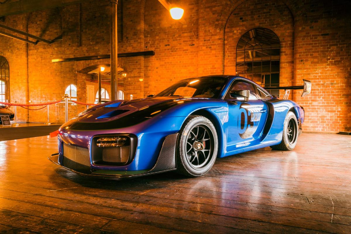 a blue and black car parked in a garage