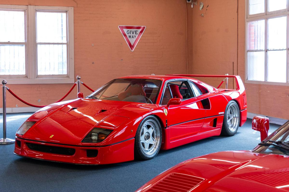 a red car is parked in a garage