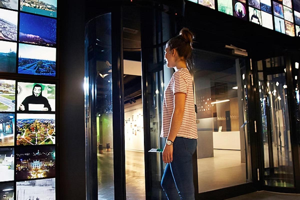 a woman standing in front of a window with a video game
