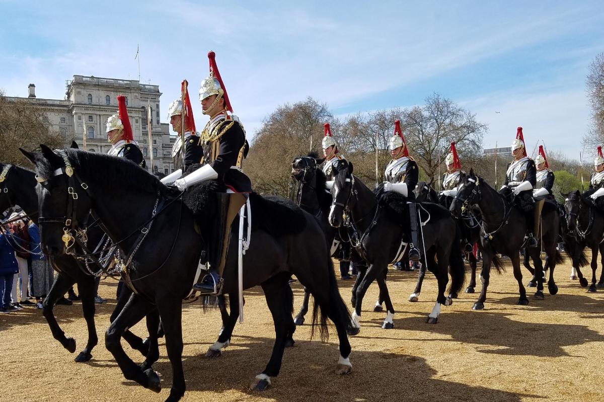 a group of men in santa hats riding on horses