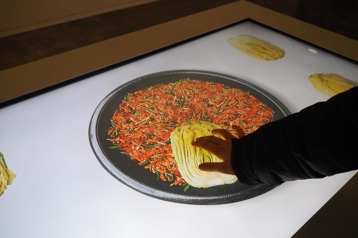 a person is preparing a plate of food on a table