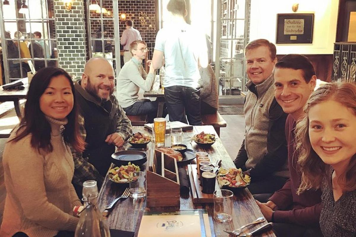 a group of people sitting around a table in a restaurant