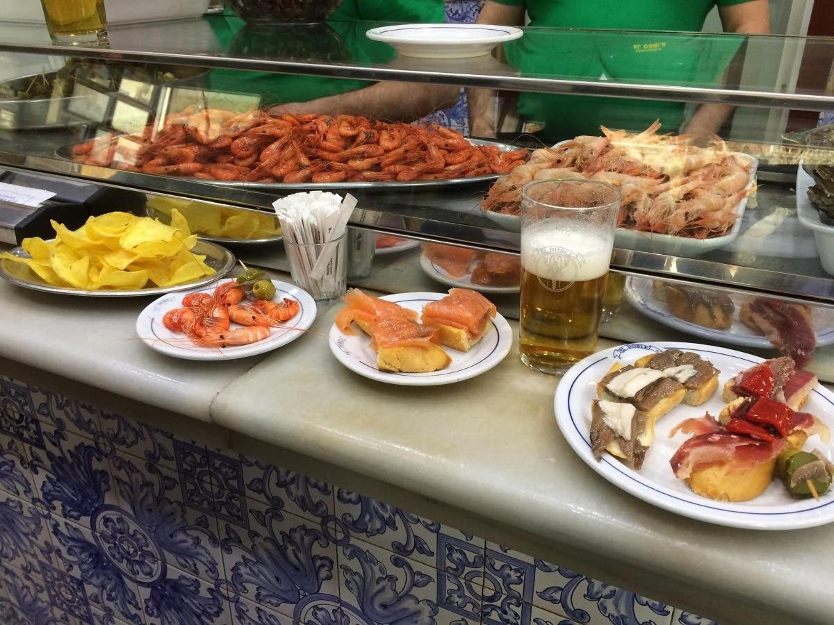 a buffet line with plates of food and drinks