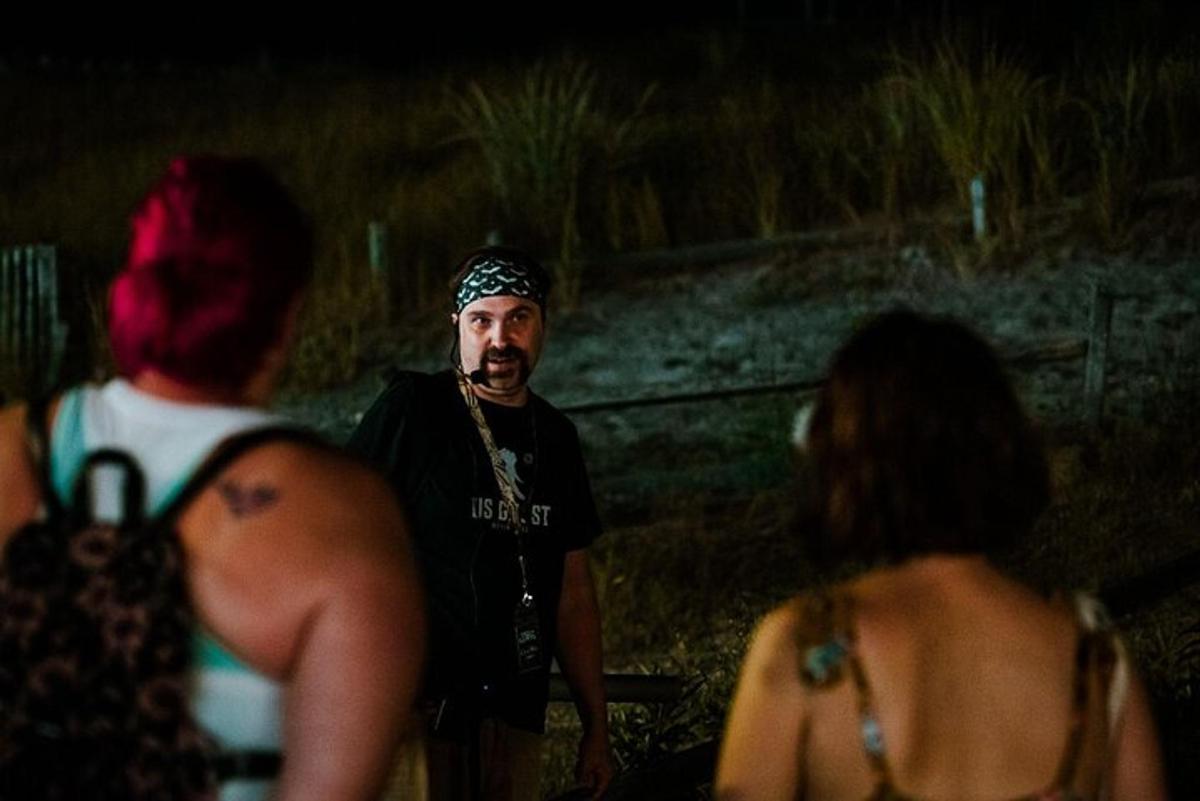 a man wearing a bandana standing in a group of people