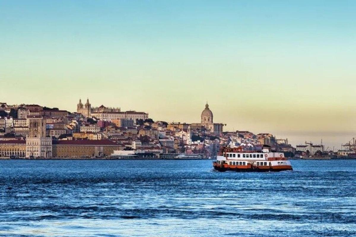 a boat in the water in front of a city