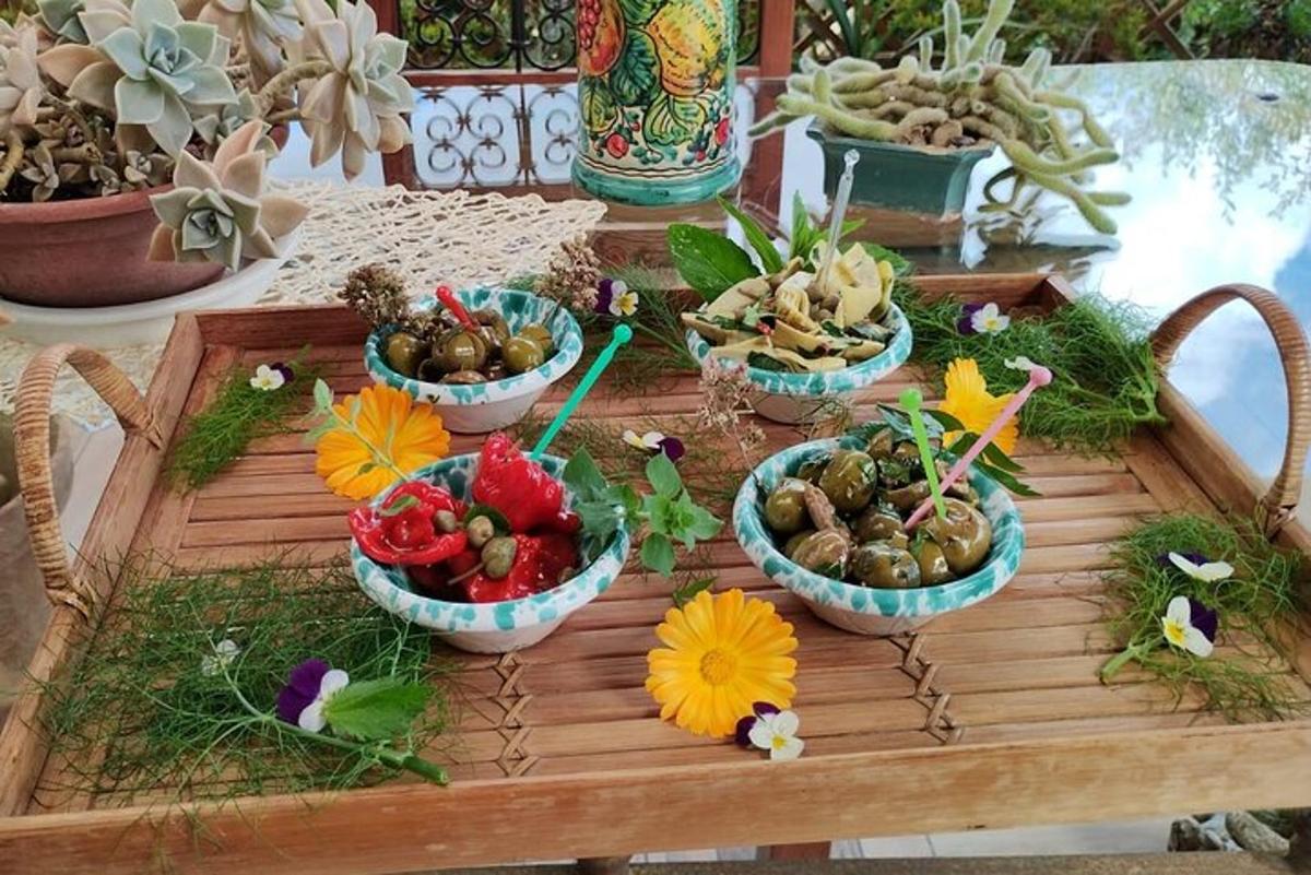 a table with four bowls of vegetables and flowers