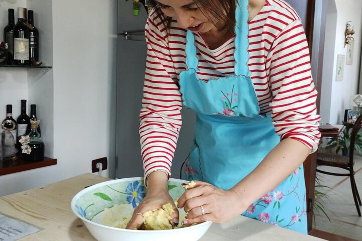 a woman in a blue apron preparing food in a bowl