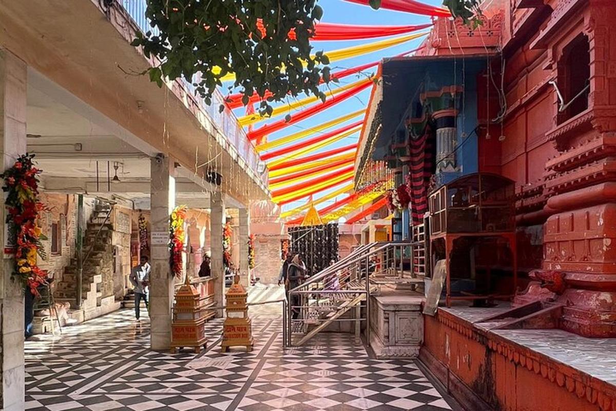 a market with a colorful canopy over a street