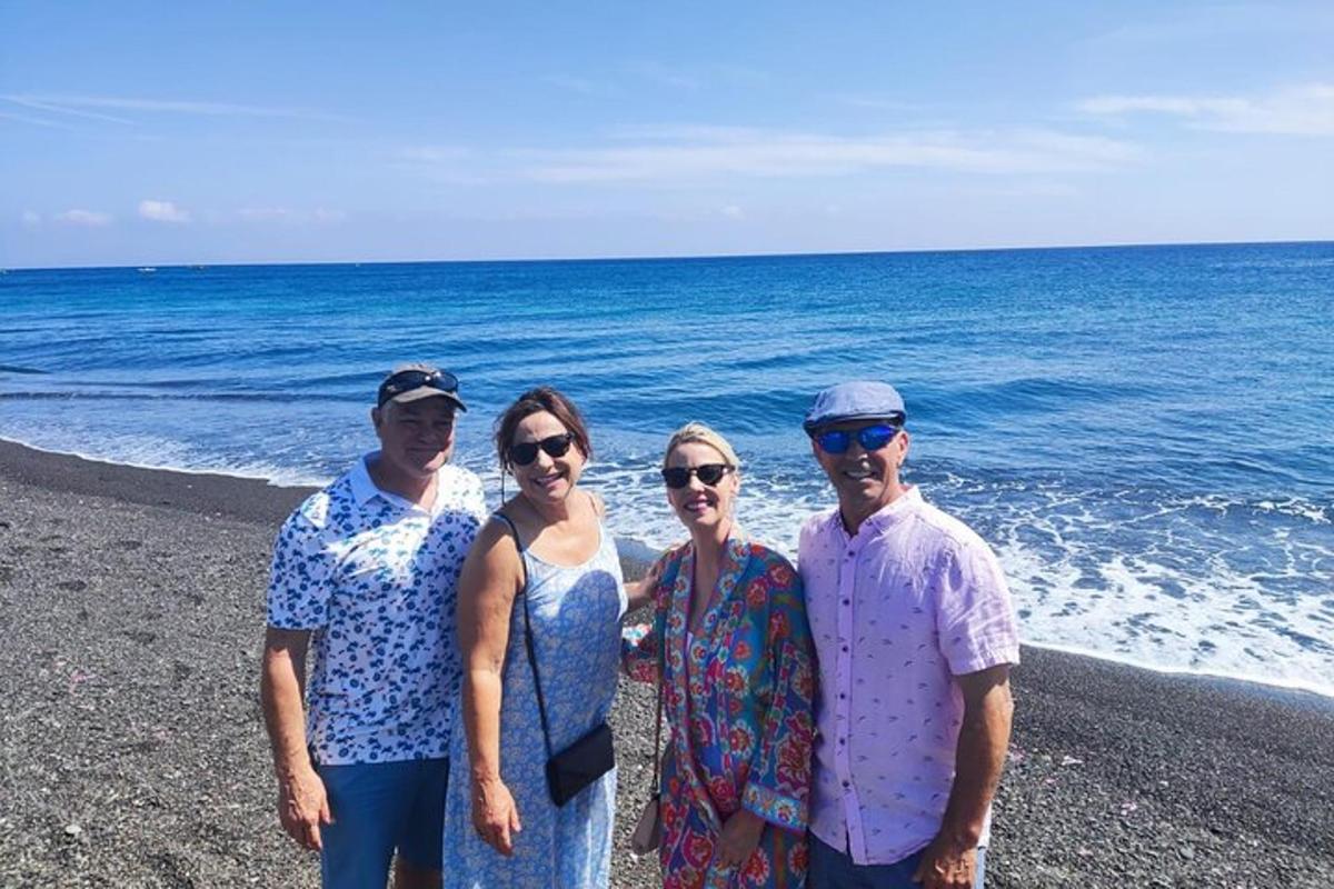 a group of people standing on the beach