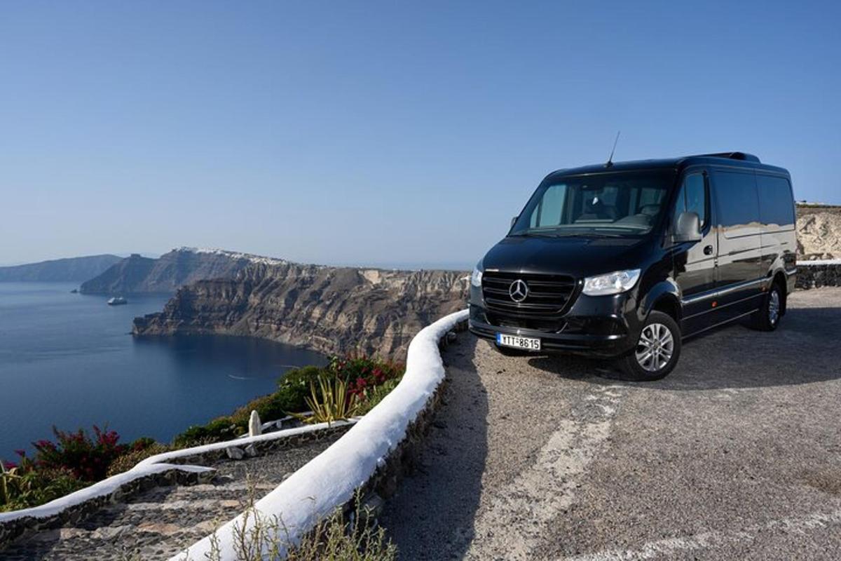 a black van parked on a road near the water