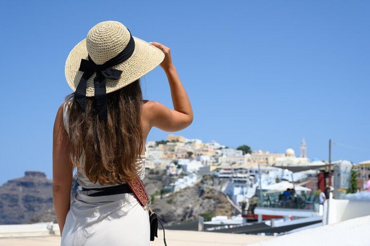 a woman wearing a hat looking at a city