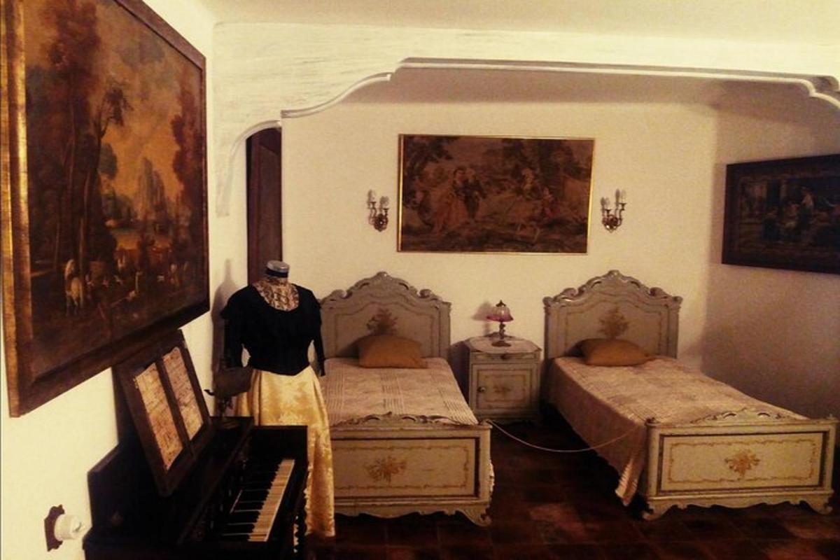 a bedroom with two twin beds and a piano
