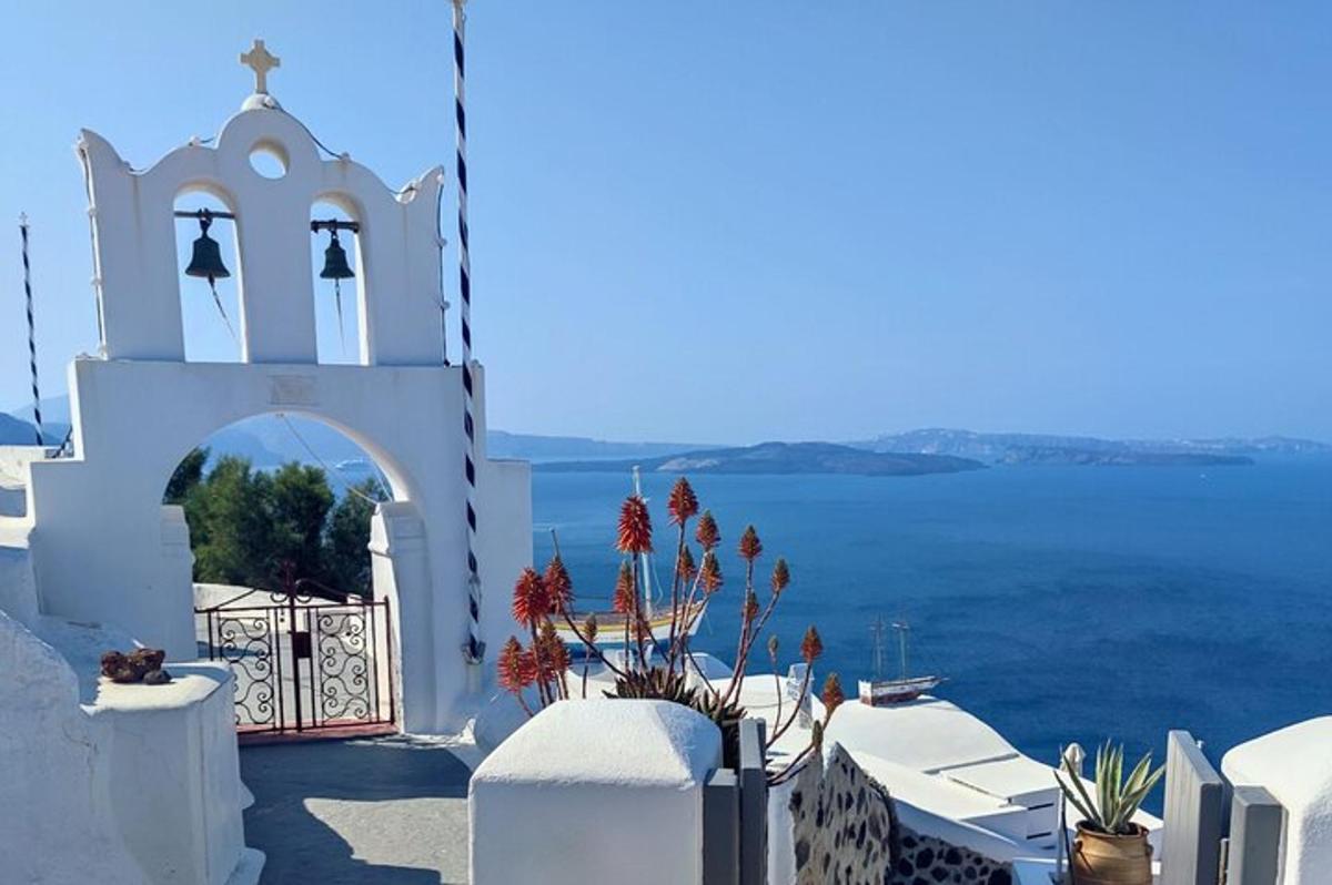 a white building with a gate and a view of the water