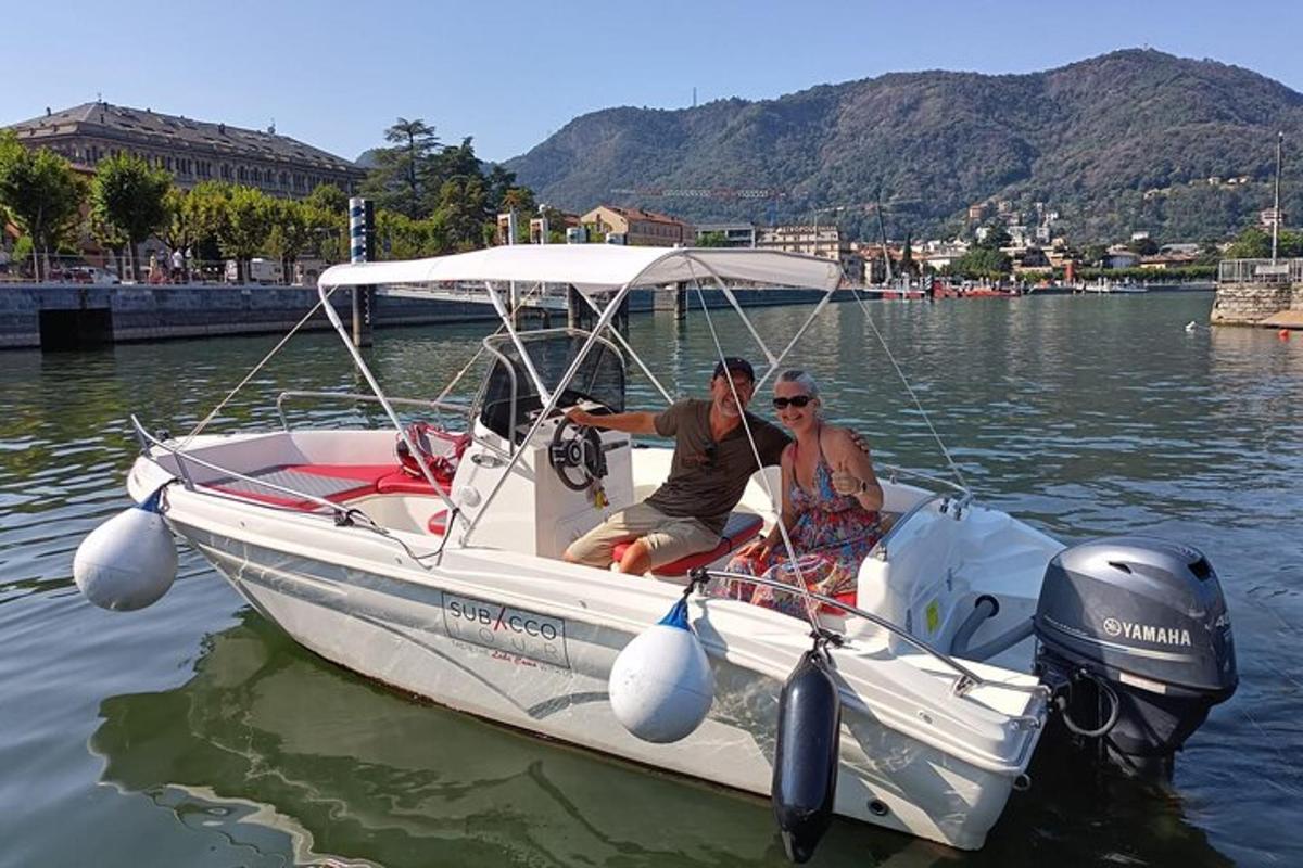 two men sitting on a boat in the water