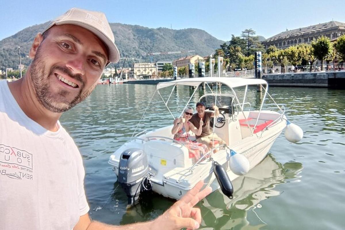 a man standing in front of a boat in the water