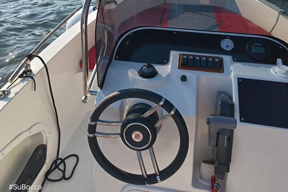 a boat with a steering wheel sitting on the water