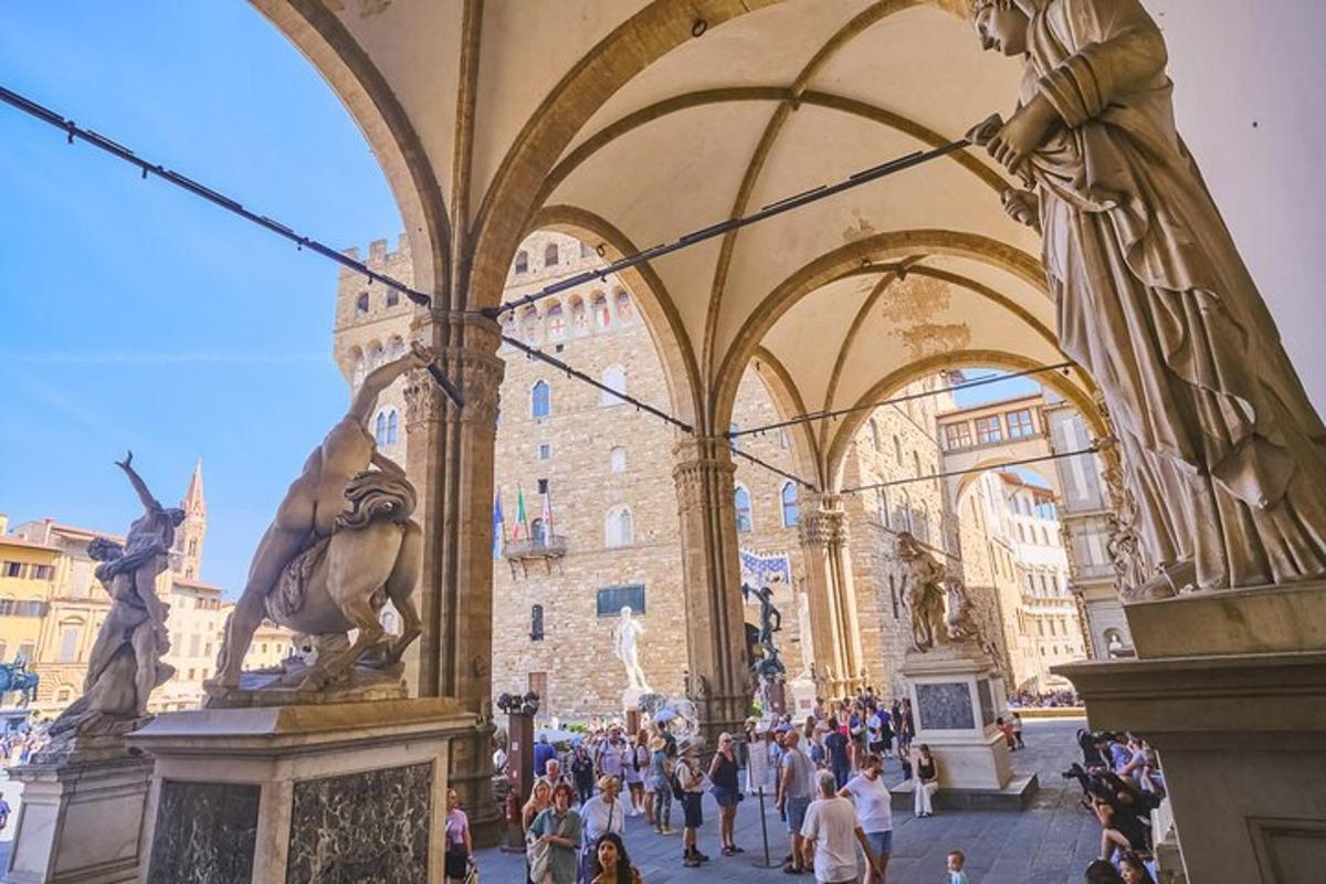 a group of people walking around a building with statues